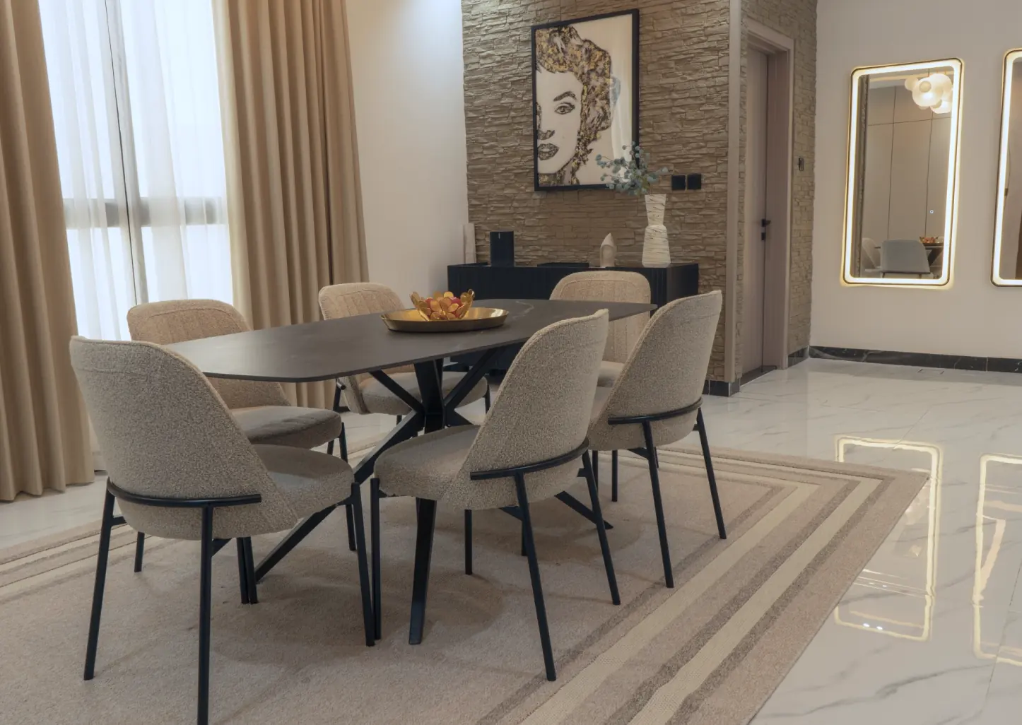 Loft Helvetia dining area with oval table and stone feature wall